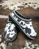 Very G black and white cow print slippers with faux fur lining and durable non-slip sole, cozy western women’s indoor outdoor shoes