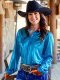 Woman wearing a turquoise metallic long sleeve zip top with rust accents