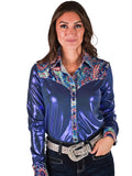 Woman wearing a shiny metallic blue button-up shirt with colorful paisley trim