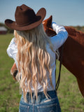 Woman wearing a white long sleeve sparkle button-up shirt with stretch fit
