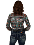 Woman wearing a colorful geometric print long sleeve button up shirt.