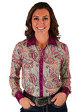 Woman wearing a colorful paisley button-up shirt with hot pink foil trim