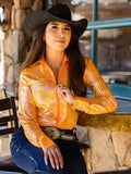 Woman wearing an orange metallic long sleeve quarter zip shirt with subtle pattern texture