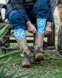 Model wearing the High Maintenance Cowgirl Sky Blue Performance Socks with boots.