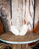 The Aztec Earmuff displayed on a wooden table with a wood back ground.