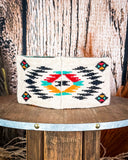 The back of the Aztec Head Wrap displayed on a wooden table with a wood back ground.