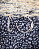 earrings laying on beans and wheat