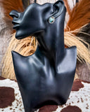 Earrings on mannequin.