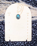 Earrings on wooden measurements.