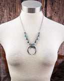 Necklace on mannequin.