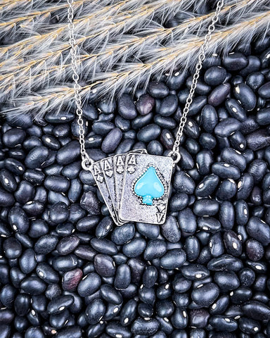 necklace laying on beans and wheat