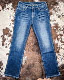 Denim Flannel Jeans laying on a cowhide rug 