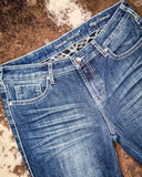 Denim Flannel Jeans laying on a cowhide rug 