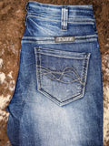 The Dare Me Trouser Jeans, folded to show the back pocket. It is displayed on cowhide.