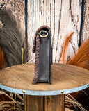 Purse displayed on wooden table.