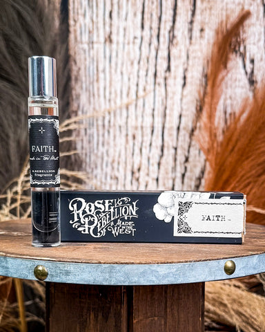 Perfume being displayed on wooden table.