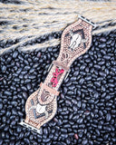 Apple Watch Fashion Band - Bone and Bloom displayed on black pebbled.