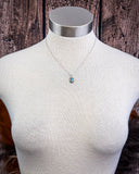Necklace being displayed on mannequin.