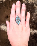 Achilles Adjustable Genuine Turquoise Ring modeled on hand.