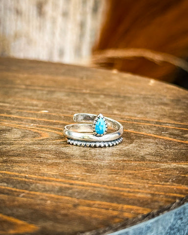 Ring displayed on wooden table.