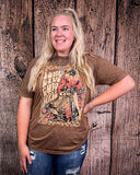 Person wearing a brown graphic t-shirt against a wooden background