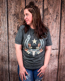 Woman wearing a graphic t-shirt with a star and horseshoe design against a wooden background