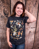 Woman wearing a black t-shirt with colorful graphics against a wooden background