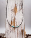 Necklace with turquoise beads on a wooden surface