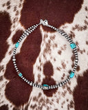 Necklace with turquoise stones on a cowhide background