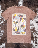 Brown t-shirt with a graphic design on a textured surface