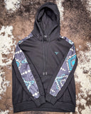Black hoodie with patterned sleeves on a textured surface