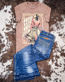 Brown graphic t-shirt and blue jeans on a cowhide rug