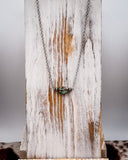 Necklace with a pendant on a rustic wooden surface