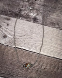 Necklace with a decorative pendant on a wooden surface