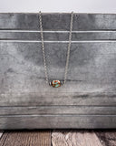 Necklace with a pendant on a wooden surface
