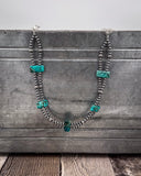Necklace with turquoise stones on a textured surface