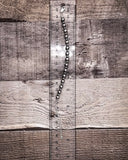 Bracelet on a wooden surface with a ruler for scale