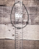 Necklace on a wooden surface with a ruler for scale