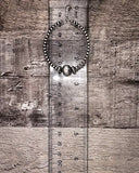 Hoop earrings with beads on a wooden surface next to a ruler