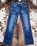 Pair of blue jeans on a textured brown surface