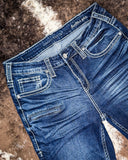 Blue jeans with brand logo on a textured surface