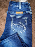 Blue jeans with a brand label on a brown surface