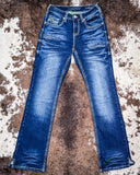 Blue jeans on a textured brown and white surface