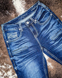 Pair of blue jeans on a textured brown surface