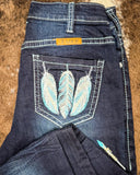 Dark blue jeans with feather design on the back pocket, brand 'TUFF' visible.