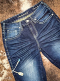 Blue jeans laid flat on a textured surface