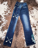 Blue jeans with decorative elements on a textured surface