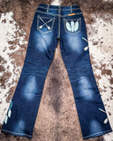 Blue jeans with embroidered designs on a textured surface