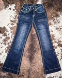 Pair of blue jeans on a textured brown surface