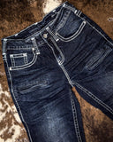 Pair of dark blue jeans on a textured brown surface